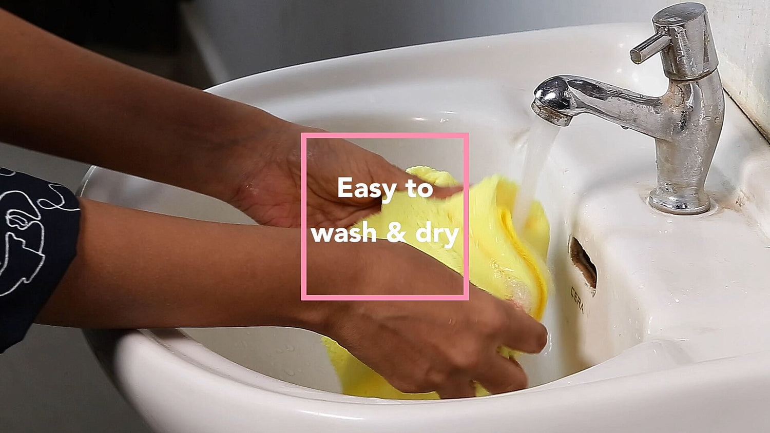 hands washing the microfiber cleaning cloth in sink.
